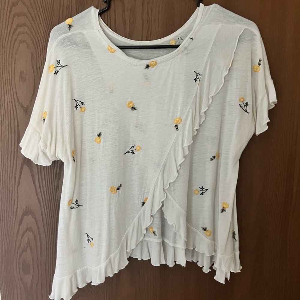 White ruffle top with yellow and green embroidered flowers